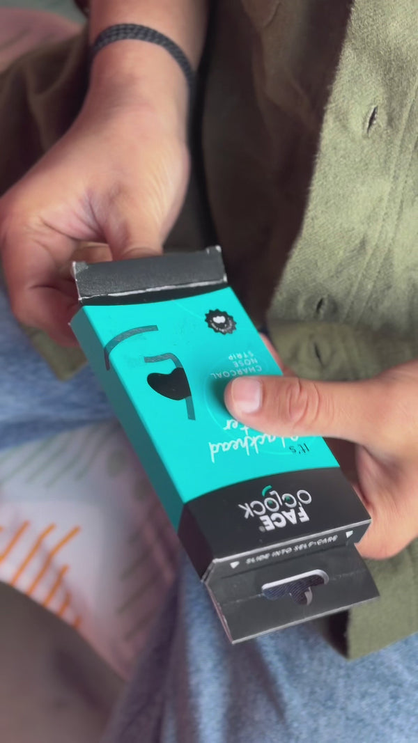 A boy getting ready for a date night by using Blackhead Beater Charcoal Nose Strip for a cleaner smoother nose as it removes clogged and dirty pores.